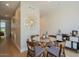 Dining area featuring seating for four, a decorative mirror wall hanging, and hardwood flooring at 7047 E Earll Dr # 1002, Scottsdale, AZ 85251