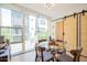 Bright dining area features a glass table, seating for four, and sliding doors leading to a balcony at 7047 E Earll Dr # 1002, Scottsdale, AZ 85251