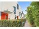 Modern townhome exterior featuring unique architecture with colorful entryway and lush landscaping at 7047 E Earll Dr # 1002, Scottsdale, AZ 85251