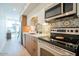 Modern kitchen featuring stainless steel appliances, stylish tile backsplash, and bright lighting at 7047 E Earll Dr # 1002, Scottsdale, AZ 85251