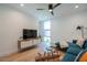 Cozy living room showcasing hardwood floors, a modern sectional sofa, designer lighting, and decorative art at 7047 E Earll Dr # 1002, Scottsdale, AZ 85251