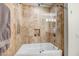 Modern bathroom with a glass-enclosed bathtub and tiled walls for a spa-like experience at 7121 E Rancho Vista Dr # 2002, Scottsdale, AZ 85251