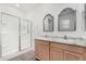 Well-lit bathroom featuring a double sink vanity and a glass-enclosed shower at 7234 E Eagle Nest Way, San Tan Valley, AZ 85143