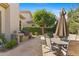 Charming backyard boasts a built-in barbecue, mature landscaping, and a dining set for enjoyable outdoor living at 7282 E Del Acero Dr, Scottsdale, AZ 85258