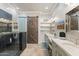 Modern bathroom featuring dual sinks, a glass-enclosed shower, and stylish barn door at 7282 E Del Acero Dr, Scottsdale, AZ 85258