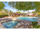 Community pool and spa with plenty of seating and shade offer a resort-like experience for residents at 7282 E Del Acero Dr, Scottsdale, AZ 85258