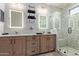 Modern bathroom featuring dual vanities, LED mirrors, and a glass enclosed walk-in shower at 7324 E Vista Bonita Dr, Scottsdale, AZ 85255