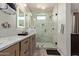 Elegant bathroom with a stylish vanity, a large glass enclosed shower with gray and white tiling at 7324 E Vista Bonita Dr, Scottsdale, AZ 85255