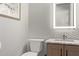 A powder room with a marble countertop and a framed landscape wall art piece at 7324 E Vista Bonita Dr, Scottsdale, AZ 85255