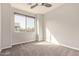 Bright, neutral bedroom with a large window, plush carpet, and natural light creating a cozy atmosphere at 7324 E Vista Bonita Dr, Scottsdale, AZ 85255