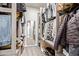 A closet with wooden shelving and a mirror, offering ample storage space for clothing and accessories at 7324 E Vista Bonita Dr, Scottsdale, AZ 85255