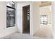 Hallway featuring an arched doorway and a view of the outdoor scenery at 8230 N Mockingbird Ln, Paradise Valley, AZ 85253