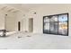 Unfinished living space featuring large windows, white walls, and customizable design at 8230 N Mockingbird Ln, Paradise Valley, AZ 85253