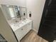 Elegant bathroom featuring a dual-sink vanity with a light-up mirror and contemporary fixtures at 8833 N 39Th Ave, Phoenix, AZ 85051