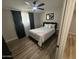 Bedroom with ceiling fan, wood floors, and closet access at 8833 N 39Th Ave, Phoenix, AZ 85051