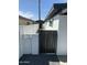 View of side yard area of home showcasing gravel, modern white wall and a gate at 8833 N 39Th Ave, Phoenix, AZ 85051