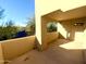 View of the balcony overlooking trees, sky, and some rooftops of neighboring buildings at 9065 E Gary Rd # 129, Scottsdale, AZ 85260