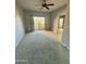 A carpeted bedroom with a ceiling fan, sliding glass door, and mirrored closet at 9065 E Gary Rd # 129, Scottsdale, AZ 85260