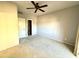 A large empty bedroom with a ceiling fan and carpeted flooring at 9065 E Gary Rd # 129, Scottsdale, AZ 85260