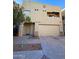 Stylish two-story townhouse featuring a stucco facade, attached garage, and desert landscaping at 9065 E Gary Rd # 129, Scottsdale, AZ 85260