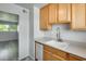 Well-lit kitchen features wood cabinets, light countertops and stainless steel faucet at 920 N 82Nd N St # H203, Scottsdale, AZ 85257