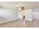 Bright living room featuring wood-look flooring, ceiling fan and views into the kitchen at 920 N 82Nd N St # H203, Scottsdale, AZ 85257