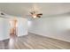 Spacious living room with modern gray flooring, ceiling fan and adjacent kitchen at 920 N 82Nd N St # H203, Scottsdale, AZ 85257