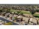 Aerial view of a well-maintained neighborhood, golf course, mature trees, and several single-Gathering homes at 1054 S Butte Ln, Gilbert, AZ 85296