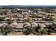 This aerial view showcases the community with mature trees, a pool, well-maintained landscaping, and proximity to amenities at 1054 S Butte Ln, Gilbert, AZ 85296