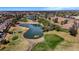 An aerial view of a well-manicured golf course community with multiple ponds and mature trees at 1054 S Butte Ln, Gilbert, AZ 85296