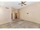 A neutral-toned bedroom with plush carpeting, ceiling fan, and ensuite access at 1054 S Butte Ln, Gilbert, AZ 85296