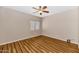 Bedroom features wood floors, neutral paint, and a bright window overlooking the yard at 1054 S Butte Ln, Gilbert, AZ 85296