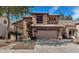 Two story home with a two car garage, tile roof, and desert landscaping at 1054 S Butte Ln, Gilbert, AZ 85296