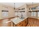 Granite island sink in a kitchen featuring wood floors, vaulted ceilings, and many windows for a comfortable space at 1054 S Butte Ln, Gilbert, AZ 85296