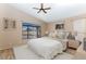 Staged main bedroom features neutral décor, window view, and ensuite bathroom at 1054 S Butte Ln, Gilbert, AZ 85296