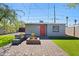 Outdoor backyard patio with outdoor seating with a firepit and green grass at 1115 E Mckinley St, Phoenix, AZ 85006