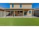 Backyard featuring a covered patio with outdoor seating and green turf at 11509 W Boca Raton Rd, El Mirage, AZ 85335