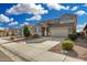 Home featuring a desert landscape, extended driveway, and a two-car garage at 11509 W Boca Raton Rd, El Mirage, AZ 85335