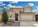 Home featuring a desert landscape, paver driveway, and a two-car garage at 11509 W Boca Raton Rd, El Mirage, AZ 85335