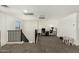 Loft featuring carpet and access to upstairs bedrooms and bathrooms at 11509 W Boca Raton Rd, El Mirage, AZ 85335