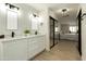 Updated bathroom with double sinks, modern lighting and access to the main bedroom at 120 W Thunderbird Rd, Phoenix, AZ 85023