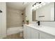 Updated bathroom with shower, vanity, and decorative mirror at 120 W Thunderbird Rd, Phoenix, AZ 85023