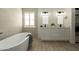 Modern bathroom features a soaking tub, dual sinks and decorative lighting at 120 W Thunderbird Rd, Phoenix, AZ 85023