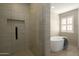 Bathroom featuring neutral tiling in the glass enclosed shower and a soaking tub at 120 W Thunderbird Rd, Phoenix, AZ 85023