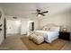 Large bedroom with neutral decor, ceiling fan, and two large decorative poufs at 120 W Thunderbird Rd, Phoenix, AZ 85023