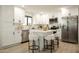 Bright kitchen features stainless steel appliances, white cabinets, and a kitchen island with bar stool seating at 120 W Thunderbird Rd, Phoenix, AZ 85023