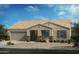 Beautiful single-story home showcasing a two-car garage and stone accents at 1414 E Jaycie Dr, Casa Grande, AZ 85122