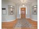 Inviting entryway featuring wood floors, elegant light fixture, and decorative wall niches at 14236 N 28Th St, Phoenix, AZ 85032