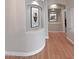 Charming hallway with hardwood floors, decorative art niches, and curved architectural details at 14236 N 28Th St, Phoenix, AZ 85032