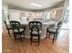 Kitchen island offers barstool seating, tile countertops, hardwood floors, and ample counter space at 14236 N 28Th St, Phoenix, AZ 85032